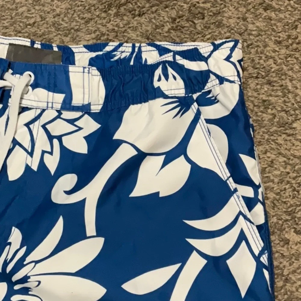 Old Navy blue & white floral swimming trunks. Size XL (40-42)